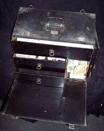 Appraisal: A tin portable medicine cabinet fitted drawers and labelled Johnson