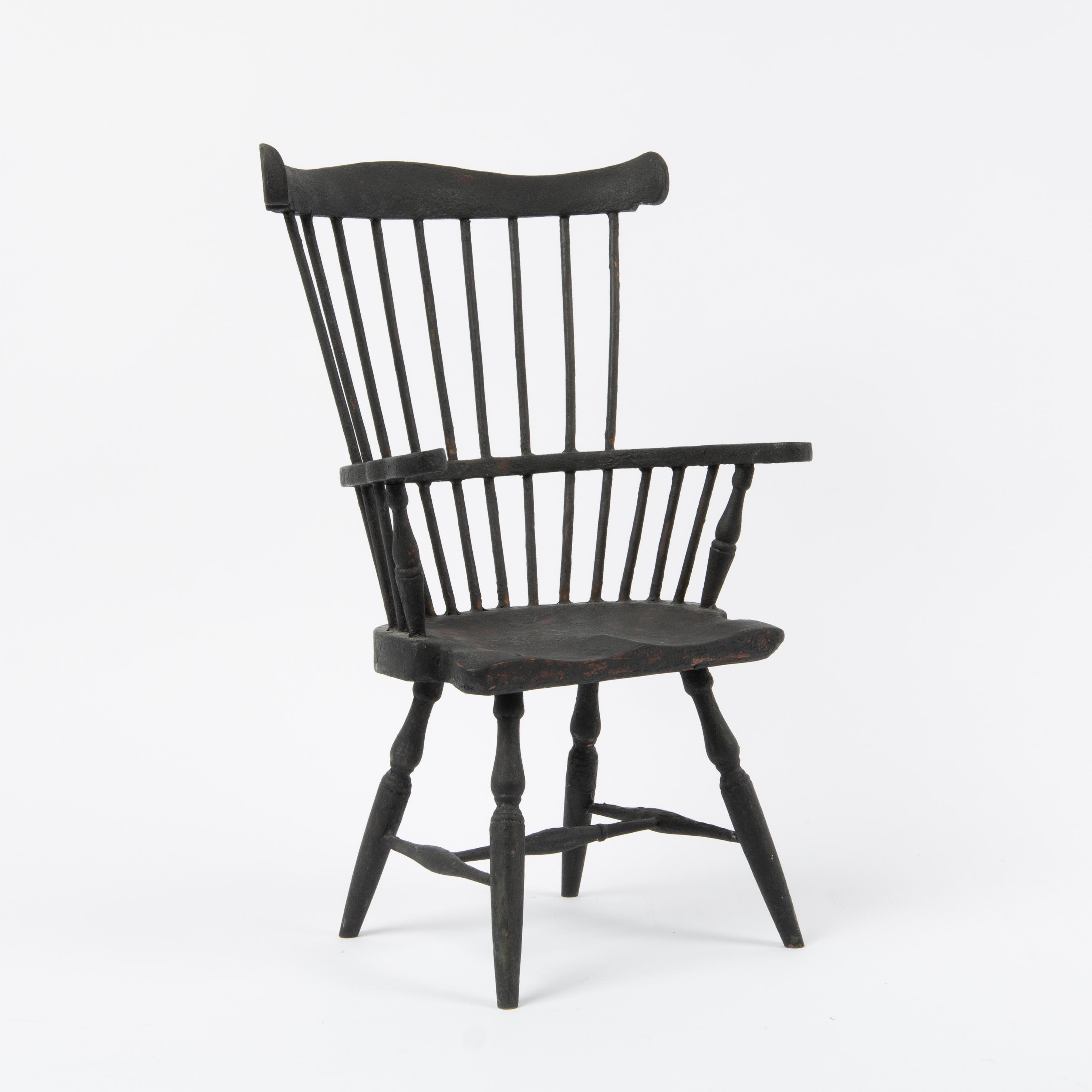 Appraisal: CHILD'S PAINTED COMB BACK WINDSOR ARMCHAIR A dry alligatored black-painted