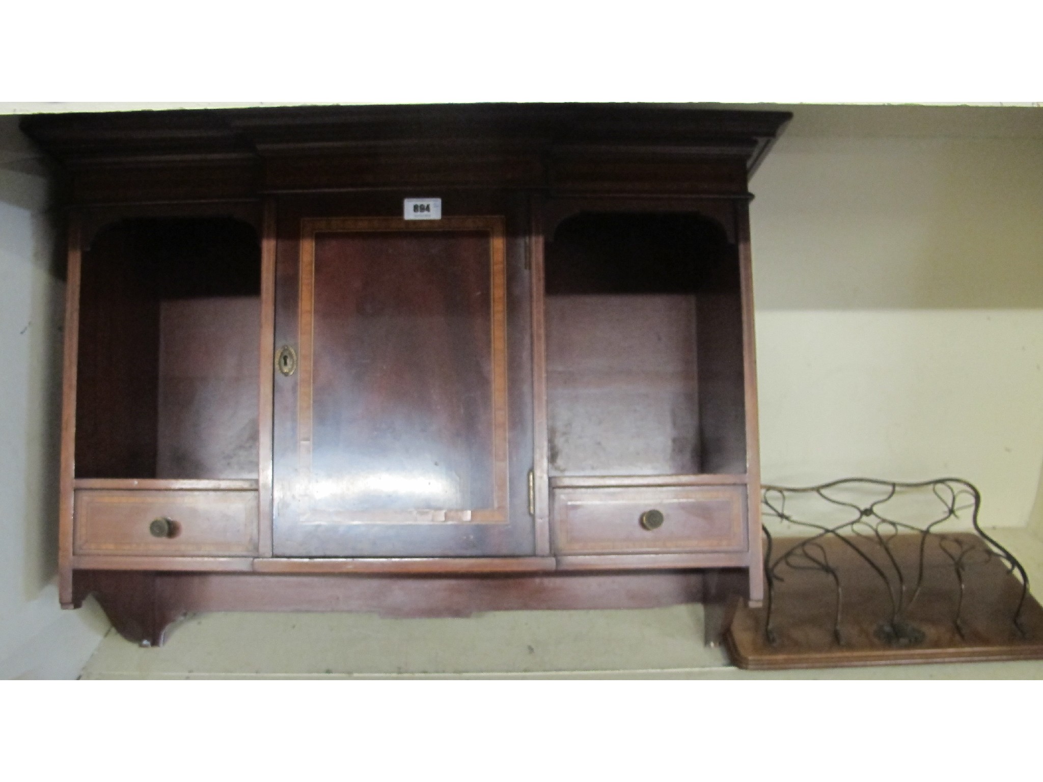 Appraisal: An Edwardian mahogany wall hanging cupboard and letter rack