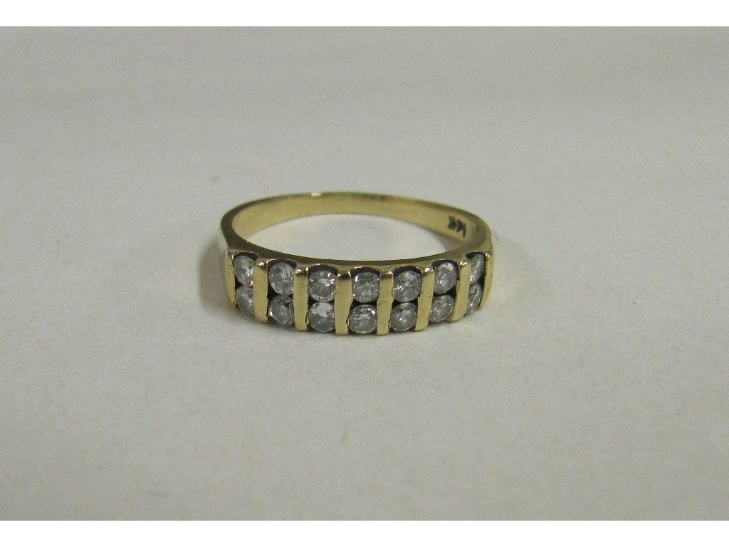 Appraisal: Fourteen carat gold channel set diamond band