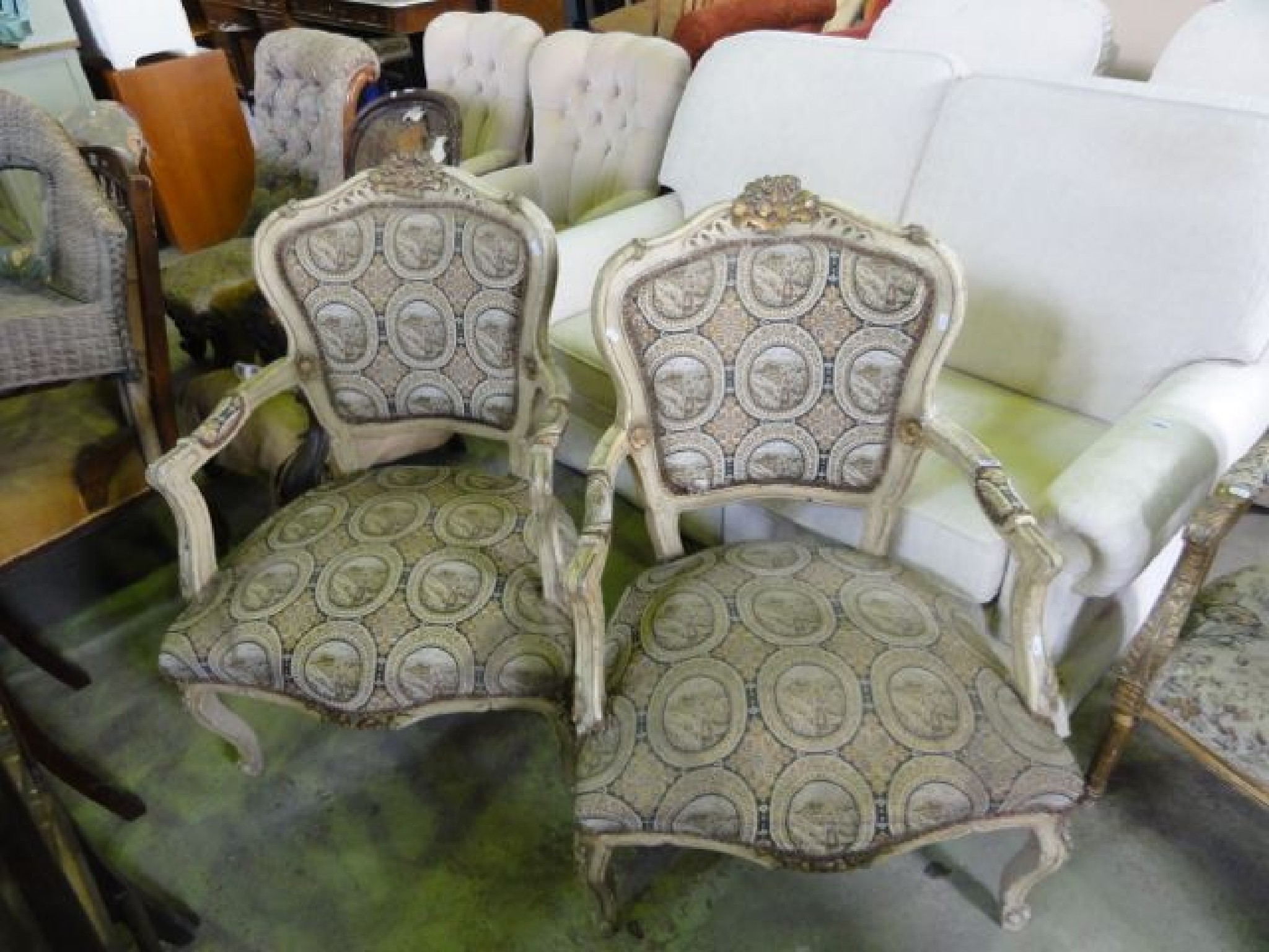 Appraisal: A pair of open armchairs with sprung upholstered serpentine seats