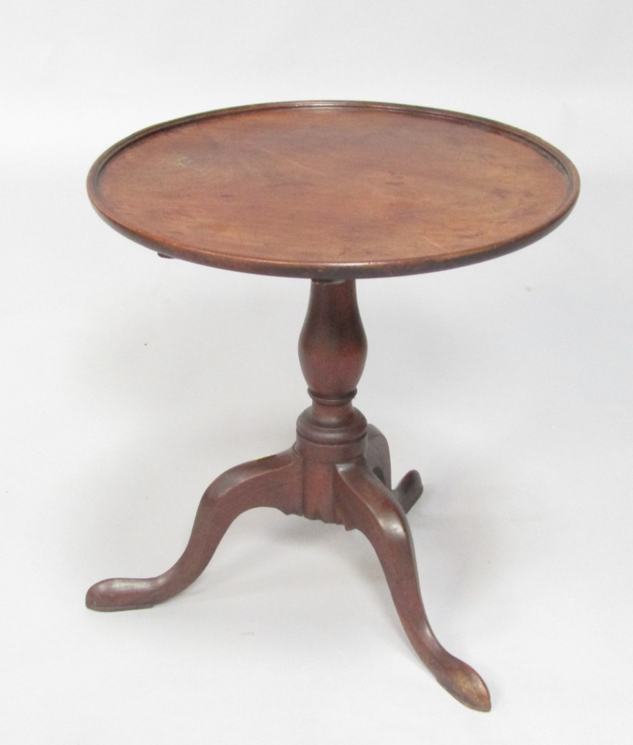 Appraisal: A George III mahogany tilt top occasional table raised on