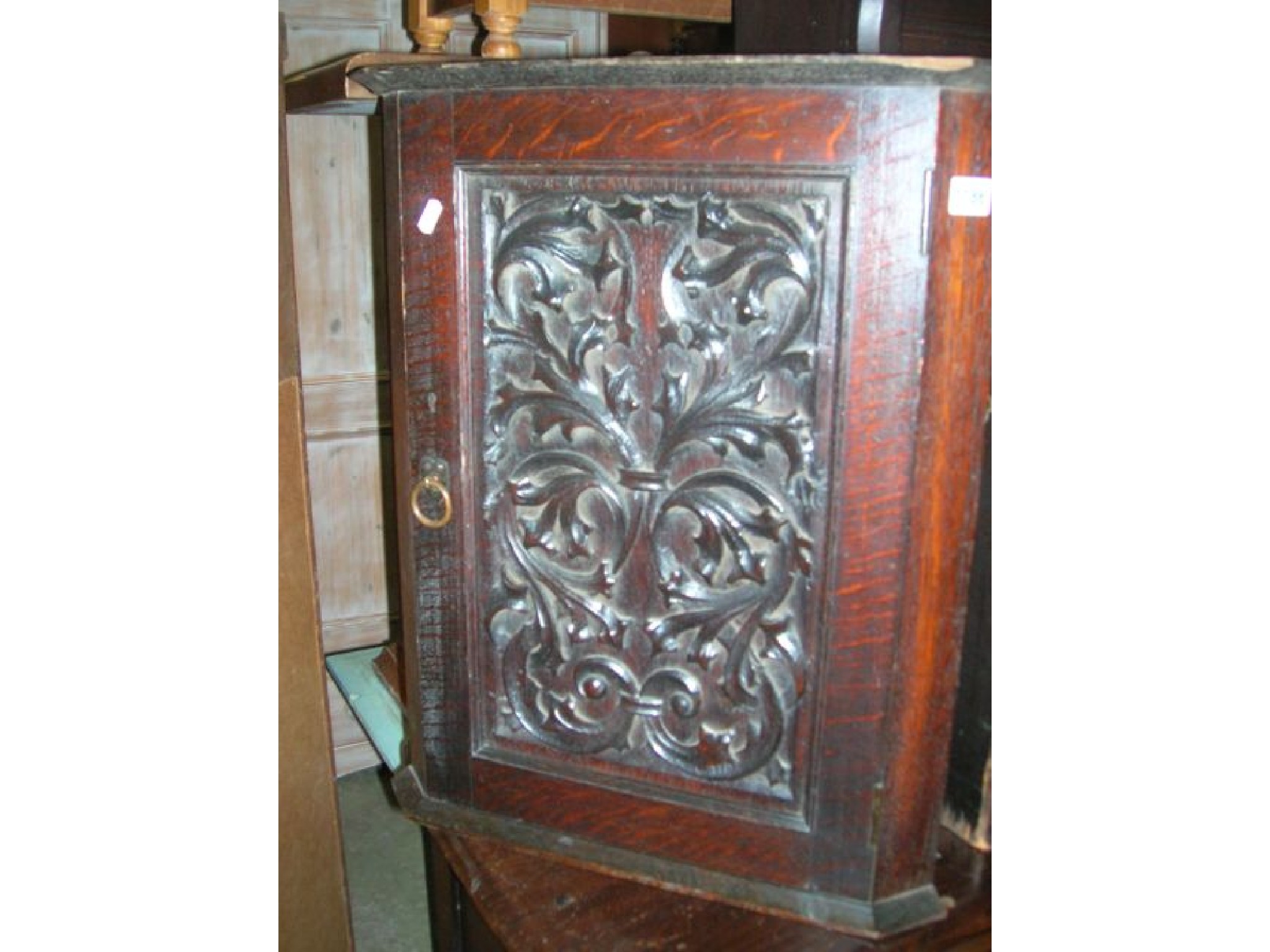 Appraisal: A small oak Arts Crafts style hanging corner cupboard enclosed