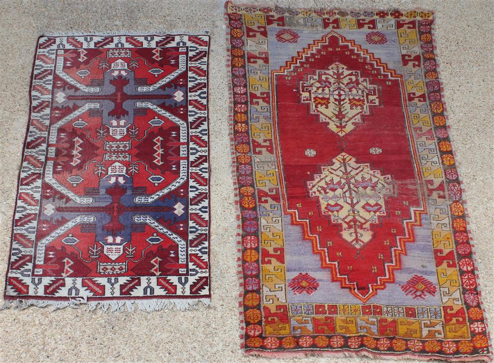 Appraisal: TWO GEOMETRIC TRIBAL WOOL RUGS the first is two medallions