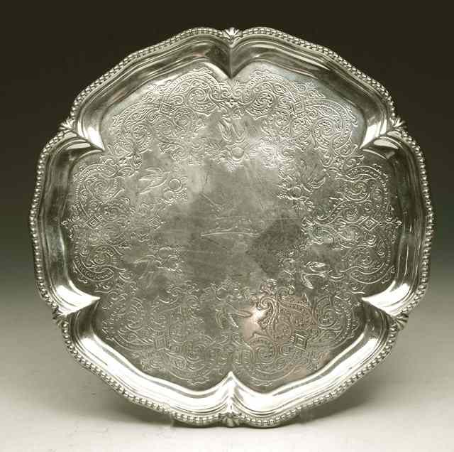 Appraisal: A VICTORIAN SILVER SALVER with shaped and beaded border ball