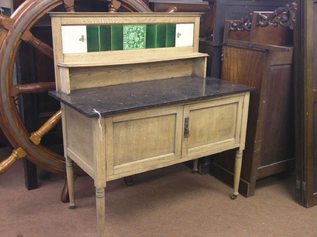 Appraisal: A Victorian stripped oak wash stand with tiled splashback and