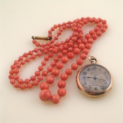 Appraisal: A graduated coral bead necklace and a gold fob watch