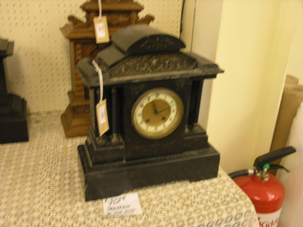 Appraisal: A Victorian black slate mantel clock architectural design with embossed