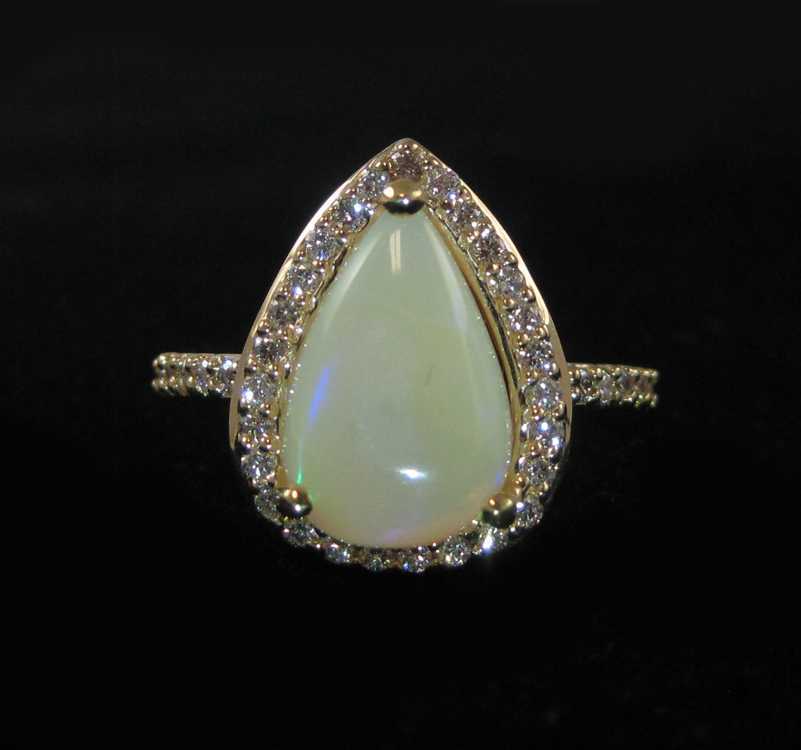 Appraisal: OPAL DIAMOND AND FOURTEEN KARAT GOLD RING with round-cut diamonds