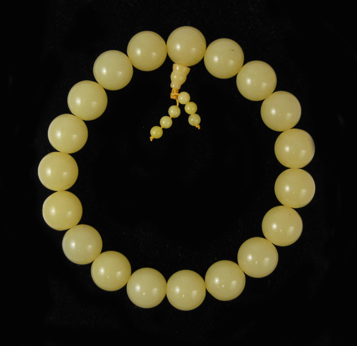 Appraisal: PRESSED BALTIC AMBER PRAYER BEADS with large light yellow amber