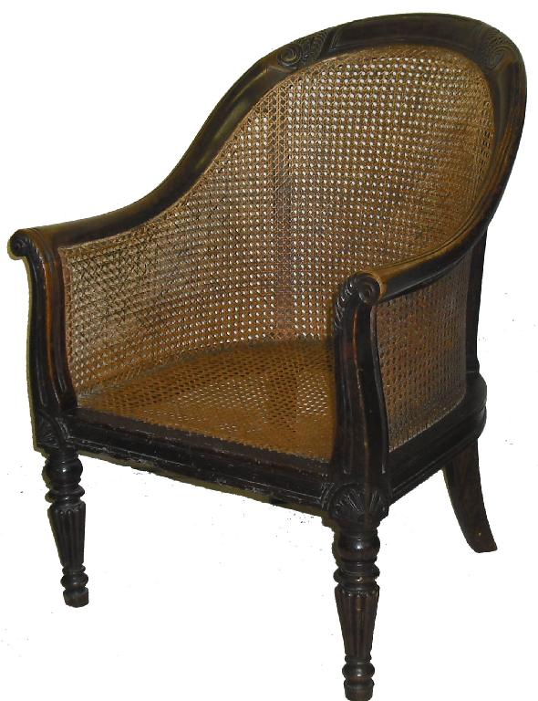 Appraisal: Regency walnut framed cane backed and seated bergere armchair with