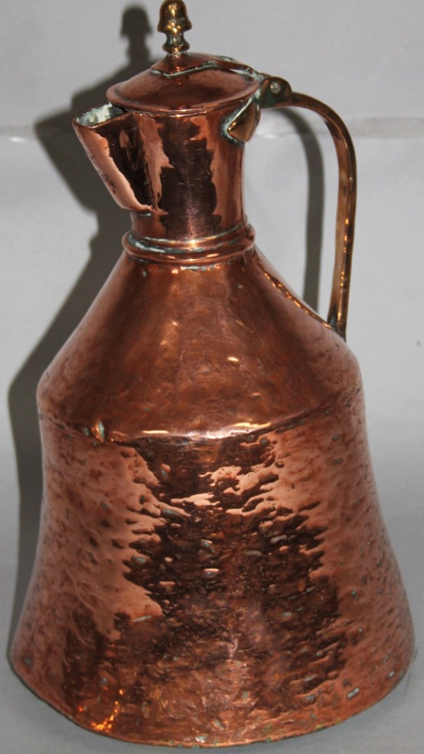 Appraisal: A late thC copper jug with brass acorn finial the