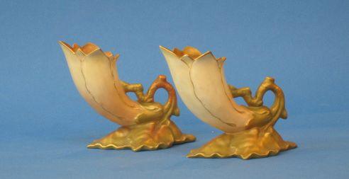 Appraisal: A PAIR OF ROYAL WORCESTER BLUSH IVORY CORNUCOPIA VASES naturalistically