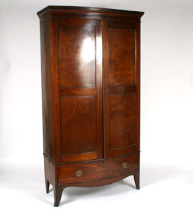 Appraisal: Mahogany bow front wardrobe footed single drawer base and two