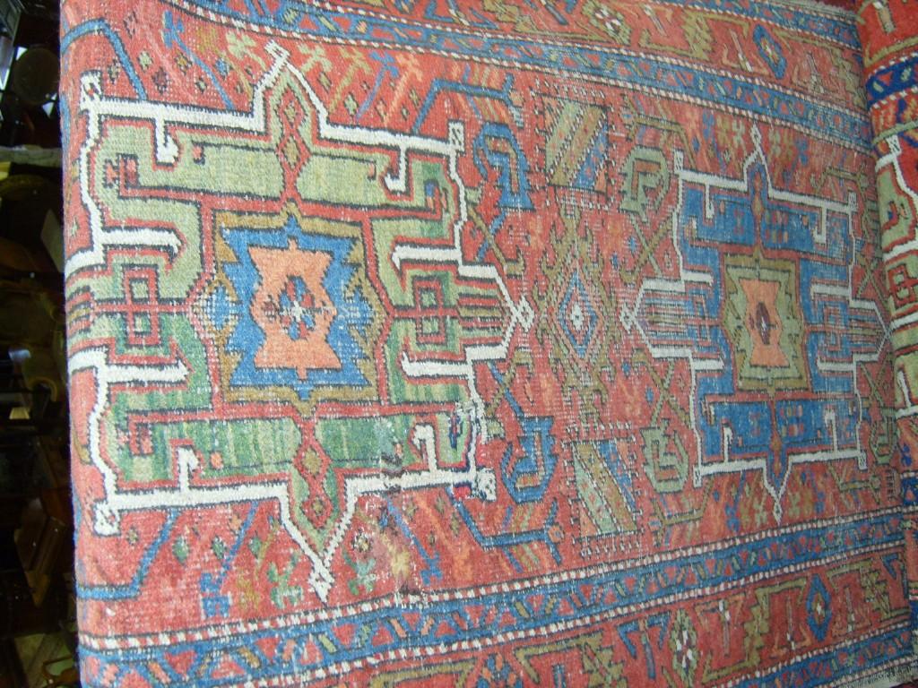 Appraisal: A red ground eastern wool runner with geometric decoration in