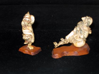 Appraisal: Japanese ivory nesuke of a foreigner and staghorn model early