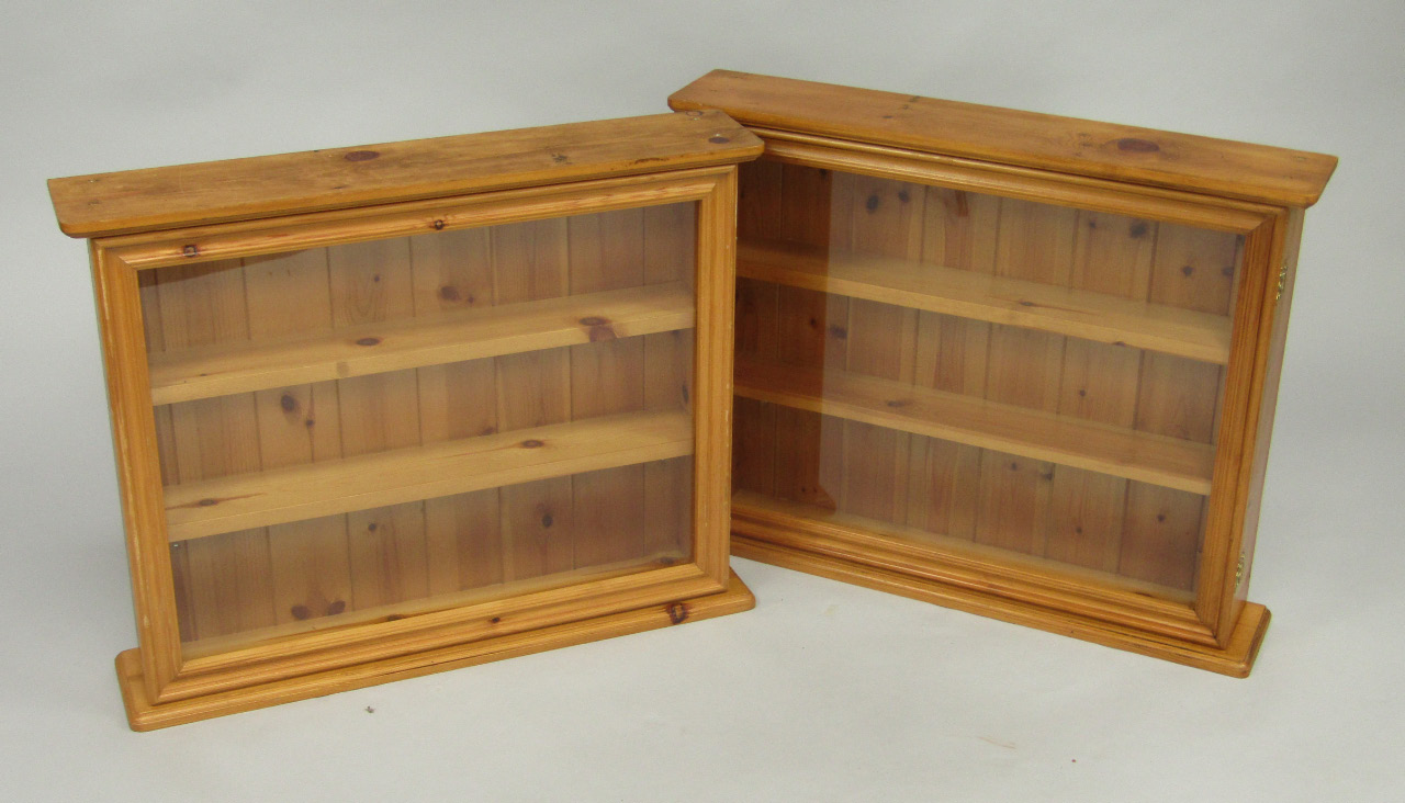 Appraisal: A pair of pine wall hanging display cabinets each with