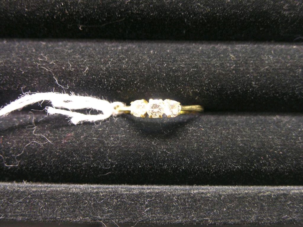 Appraisal: An ct gold three stone diamond ring in claw setting