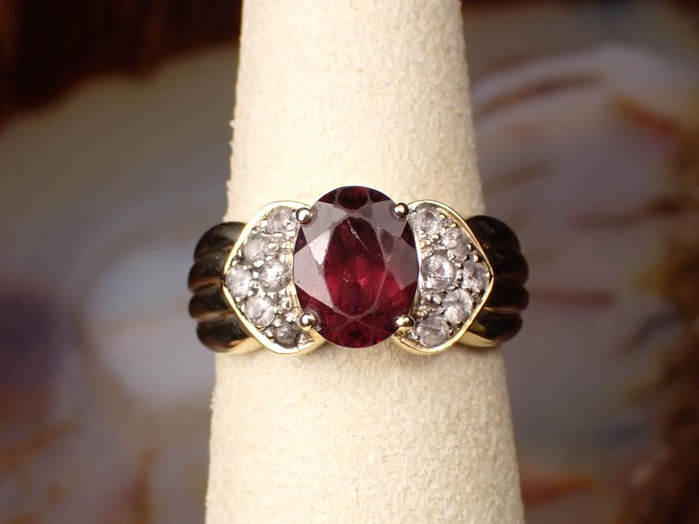 Appraisal: GARNET AND FOURTEEN KARAT YELLOW GOLD RING with six round-cut