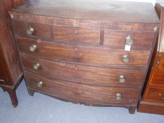 Appraisal: A late Regency mahogany bowfront chest of three short and