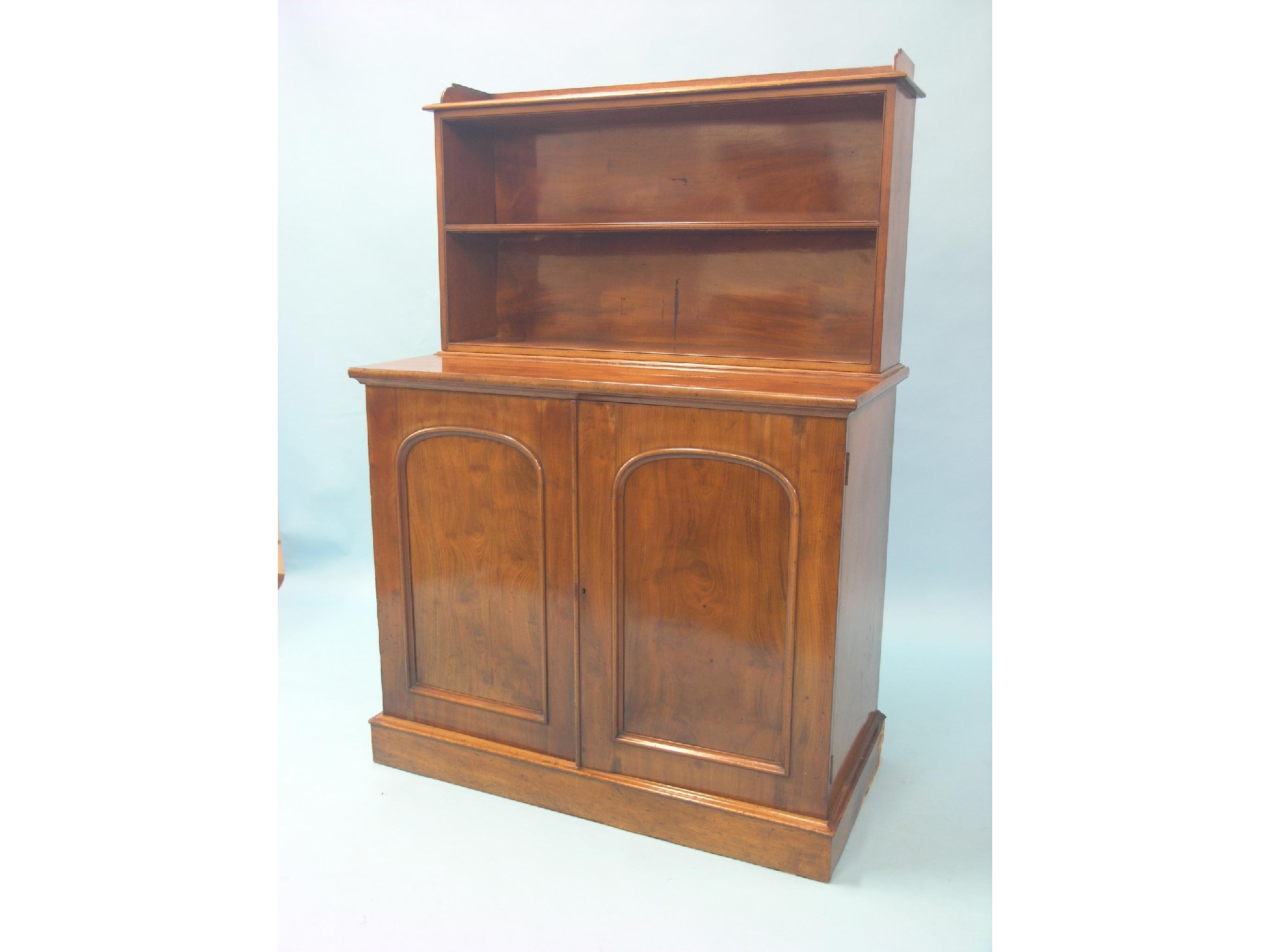 Appraisal: An early Victorian mahogany chiffonier two open shelves above panelled