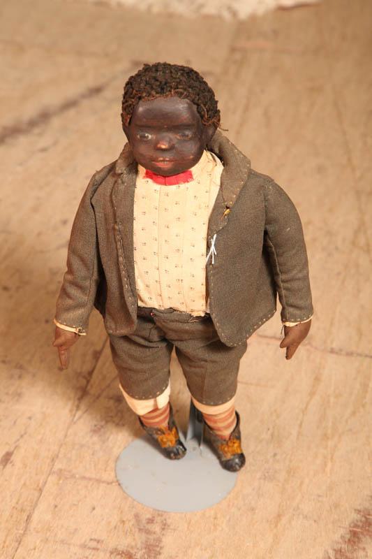 Appraisal: BLACK STOCKINETTE DOLL Wearing a heandsewn costume and having painted