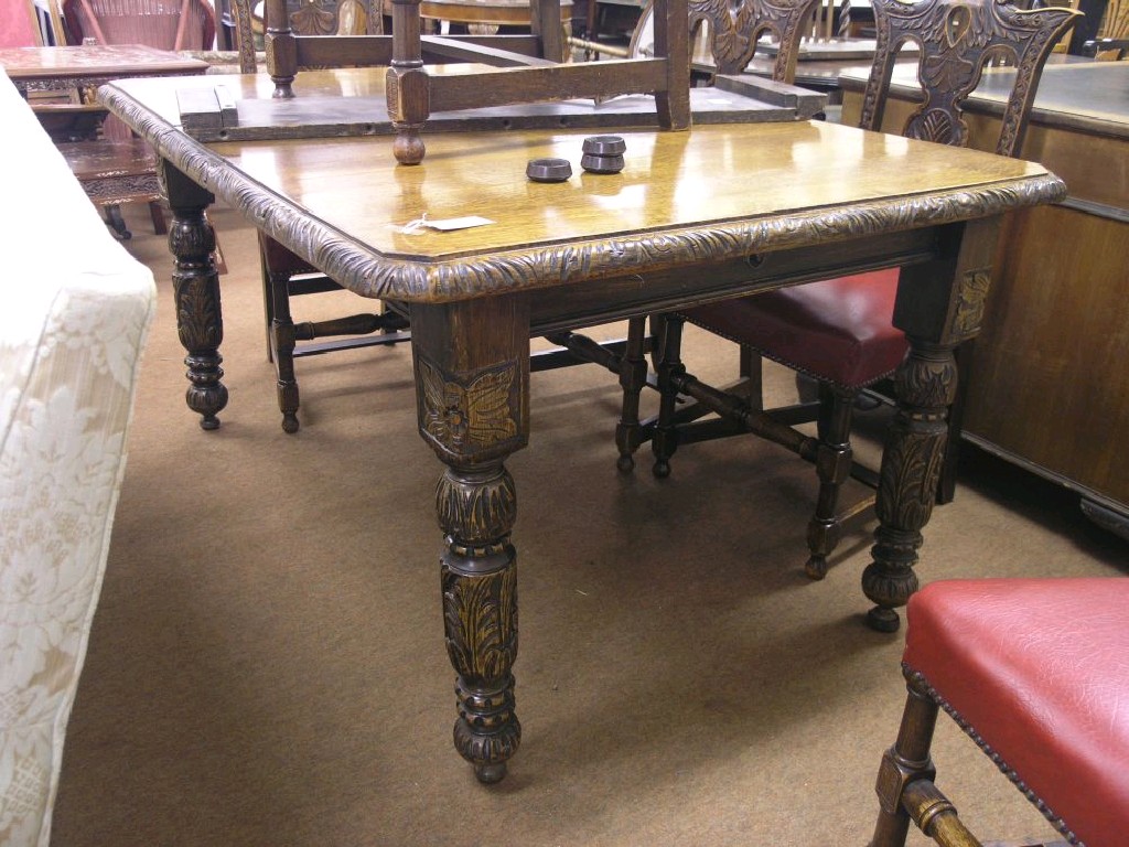 Appraisal: A late Victorian carved dark oak dining table wind-action with