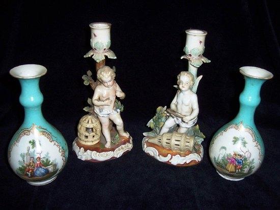 Appraisal: A pair of Continental figural candlesticks each with putti on