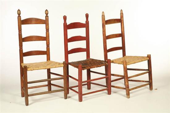 Appraisal: THREE LADDERBACK SIDE CHAIRS American early th century mixed woods