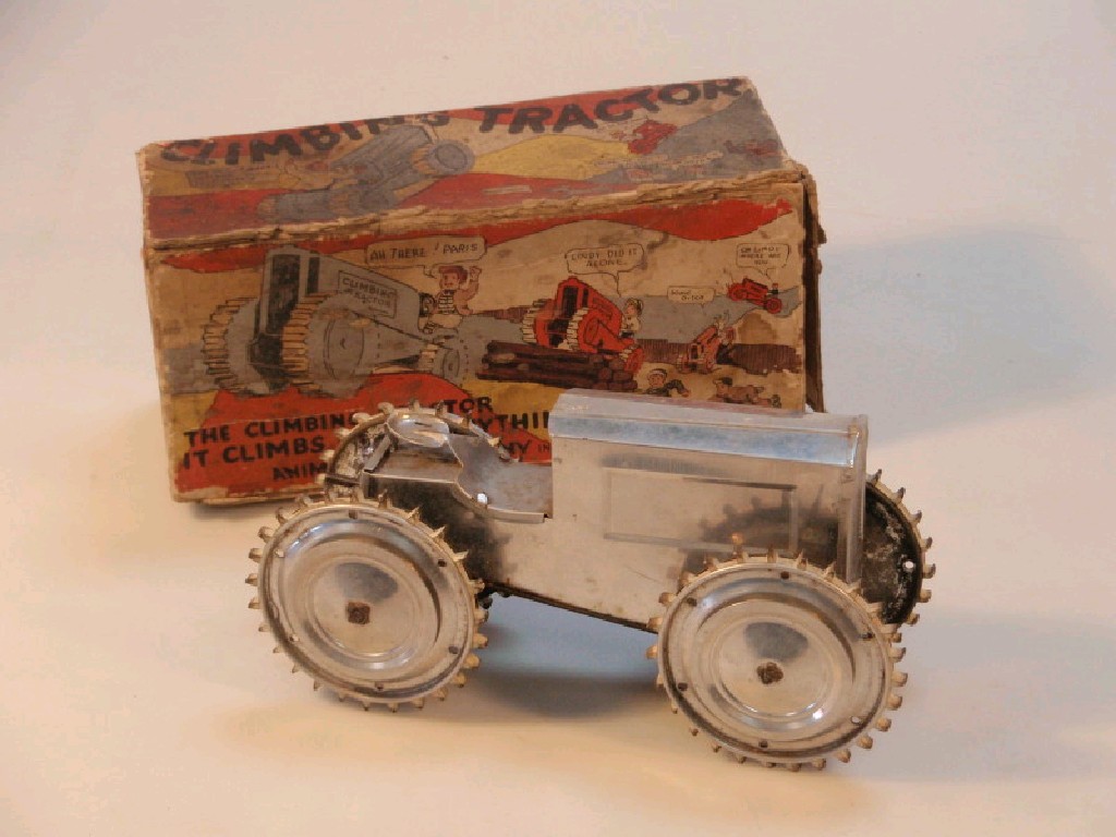 Appraisal: A chrome tin plate climbing tractor Animate Toy Co New