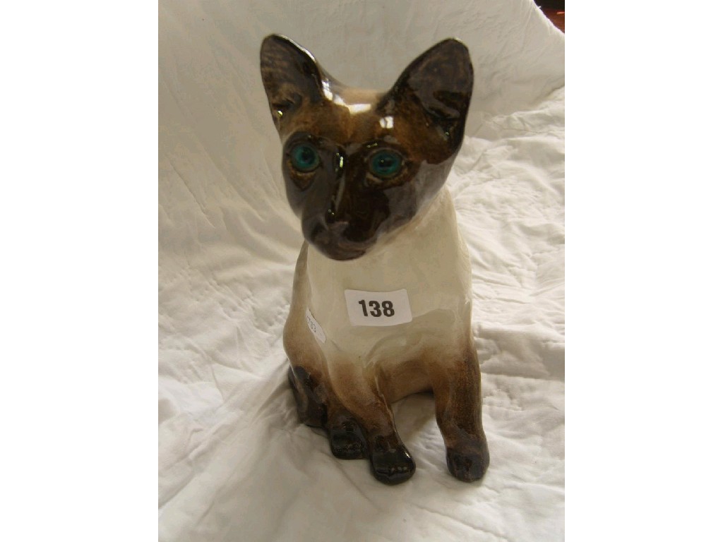 Appraisal: A Winstanley model of a seated Siamese cat with turquoise