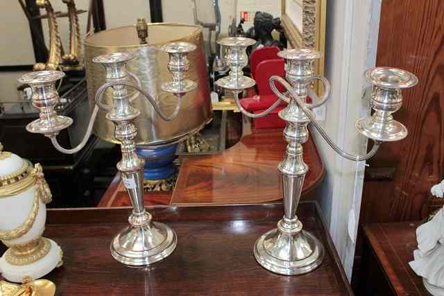 Appraisal: A PAIR OF SHEFFIELD PLATED TWO BRANCH CANDELABRA on turned