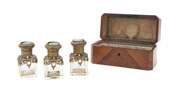 Appraisal: A Victorian Perfume Set comprising three glass bottles with enamel