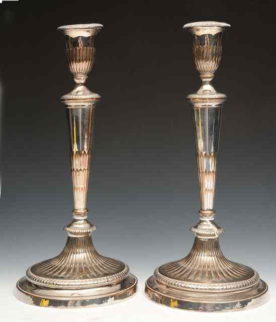 Appraisal: A PAIR OF OLD SHEFFIELD PLATE ADAM STYLE CANDLESTICKS each