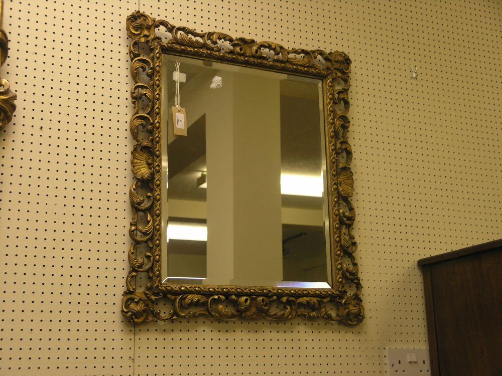 Appraisal: A rococo style gilt framed mirror with bevelled plate ft