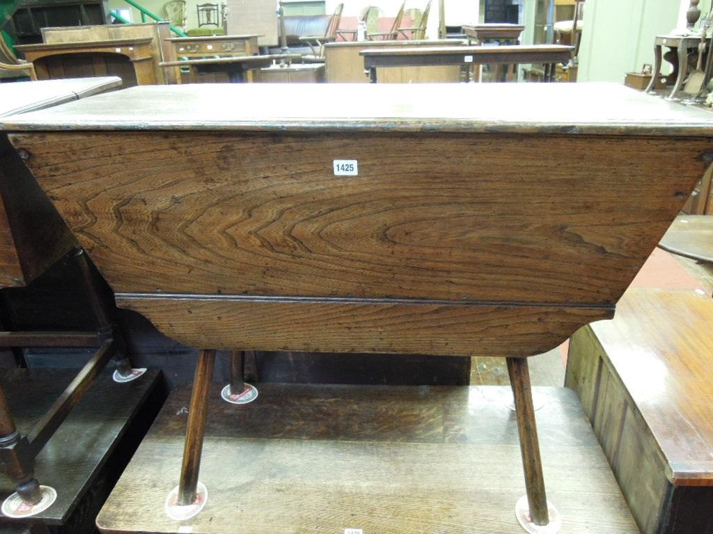 Appraisal: A Georgian elm dough bin of tapered rectangular form raised