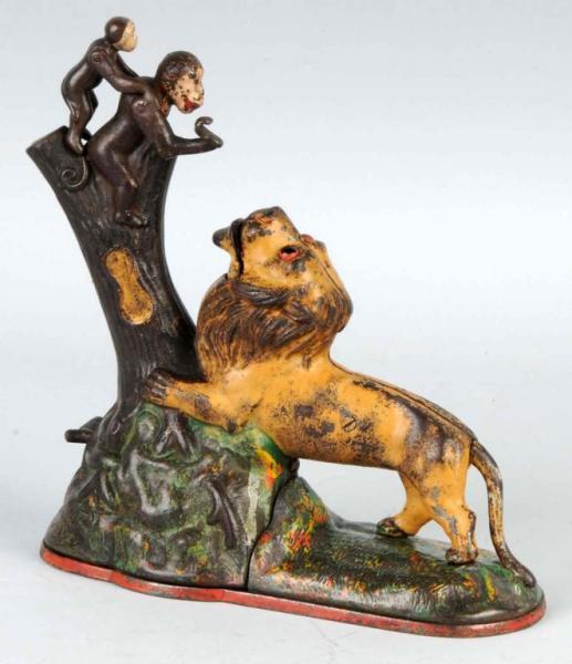 Appraisal: Cast Iron Lion Monkeys Mechanical Bank Description Manufactured by Kyser