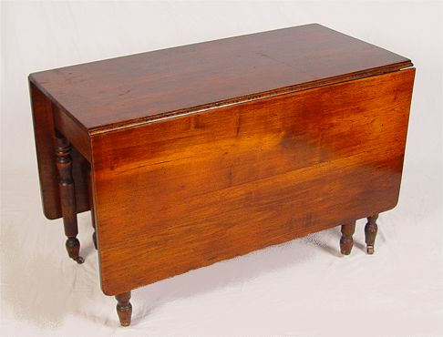 Appraisal: th C CHERRY DROPLEAF TABLE ON CASTORS One board leaves