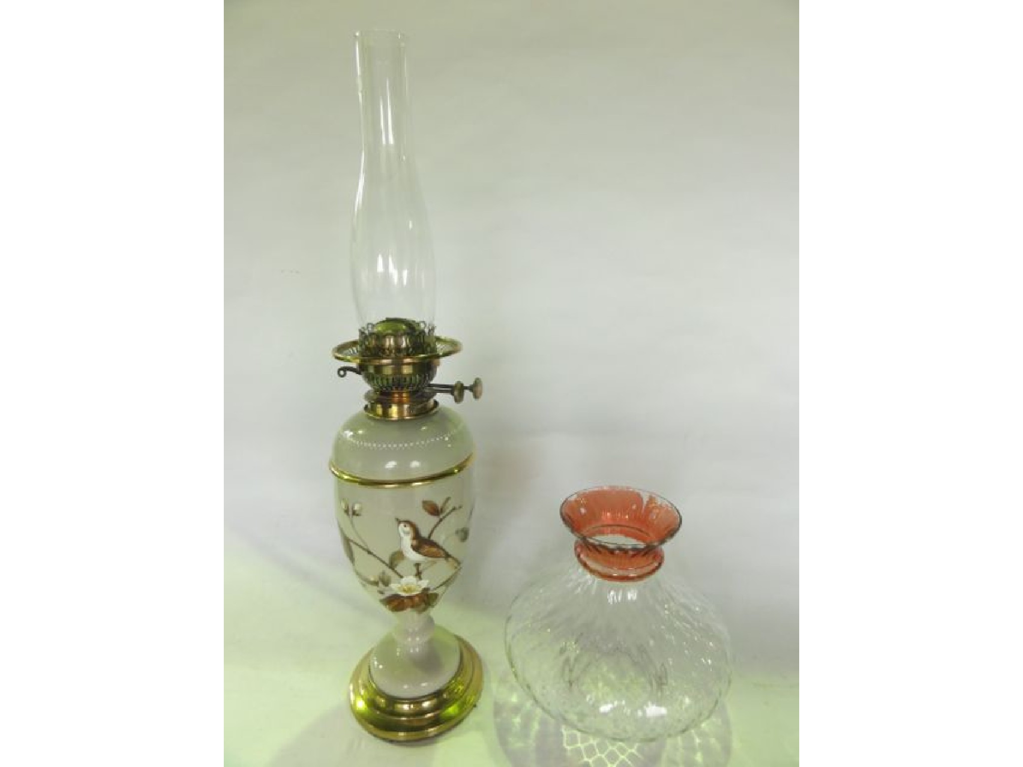 Appraisal: A th century oil burning lamp with opaque glass sectional