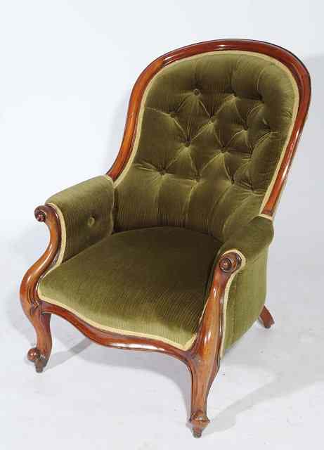 Appraisal: A VICTORIAN MAHOGANY BUTTON UPHOLSTERED LIBRARY ARMCHAIR with scrolling arms