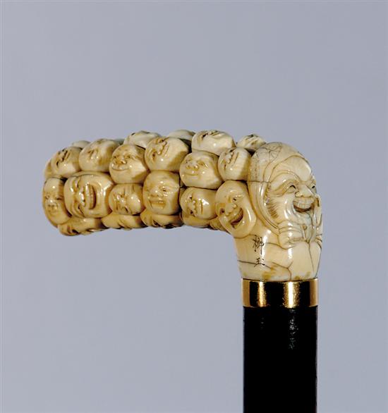 Appraisal: Japanese carved ivory cane late th century L-shaped handle carved