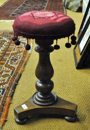 Appraisal: A Victorian mahogany revolving piano stool on baluster pillar