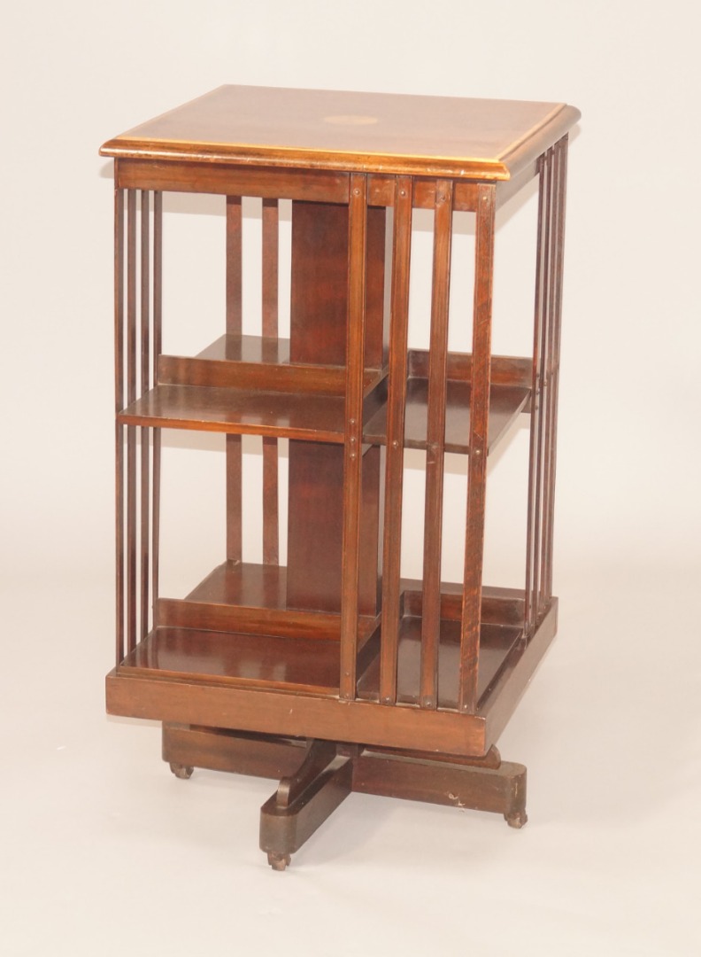 Appraisal: An Edwardian mahogany and marquetry revolving bookcase the rectangular top