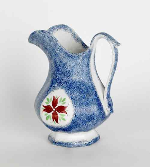 Appraisal: Blue spatter pitcher with a cluster of buds th c