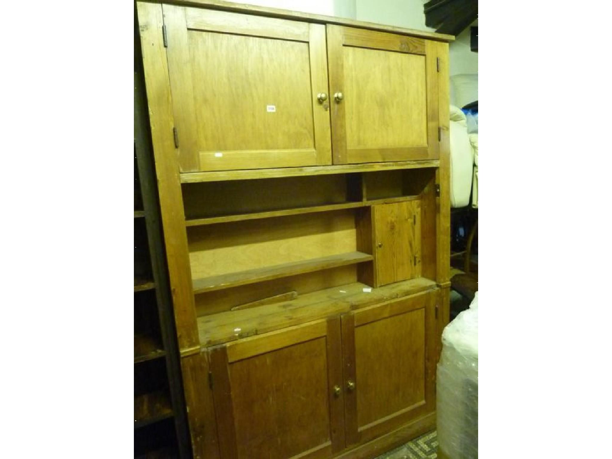 Appraisal: A stripped pine floor standing housekeepers cupboard enclosed by two