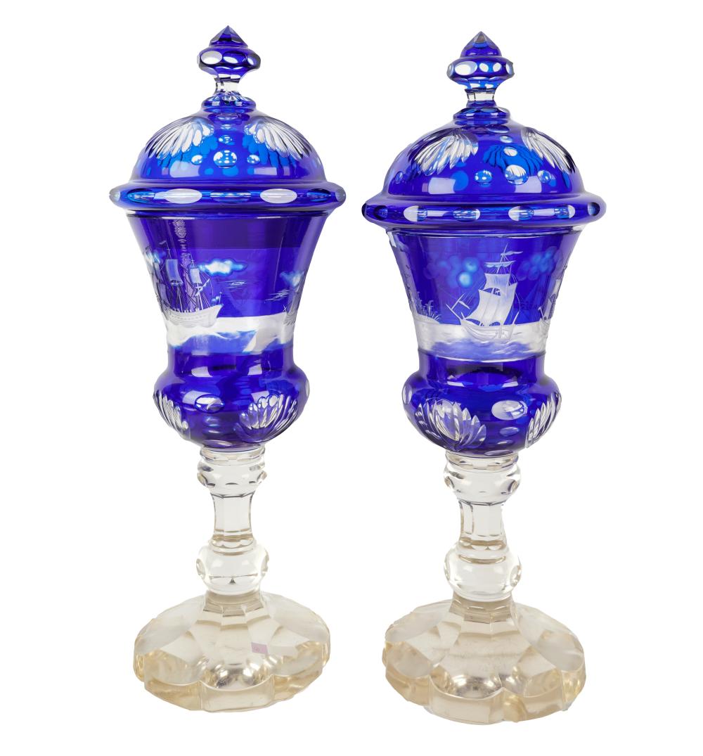 Appraisal: PAIR OF BOHEMIAN GLASS COVERED URNSunsigned depicting ships at sea