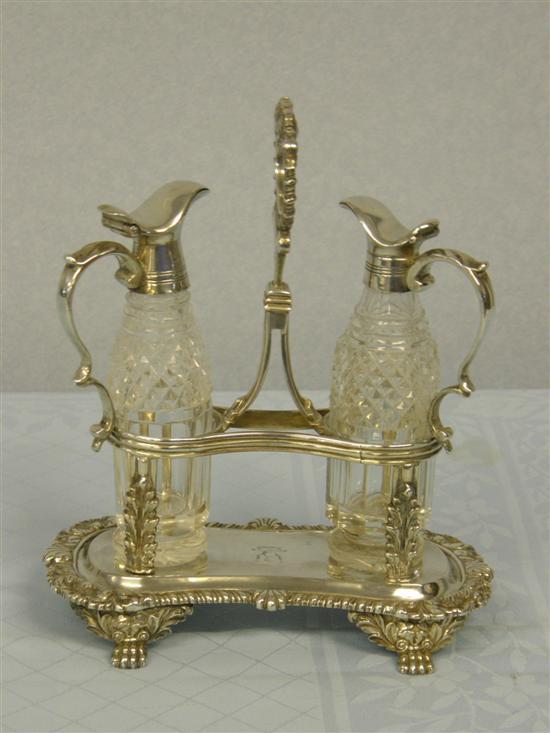 Appraisal: George IV silver two bottle stand with foliate embossed handle