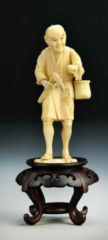 Appraisal: Japanese Carved Ivory Okimono On Hardwood StandFinely carved to depict