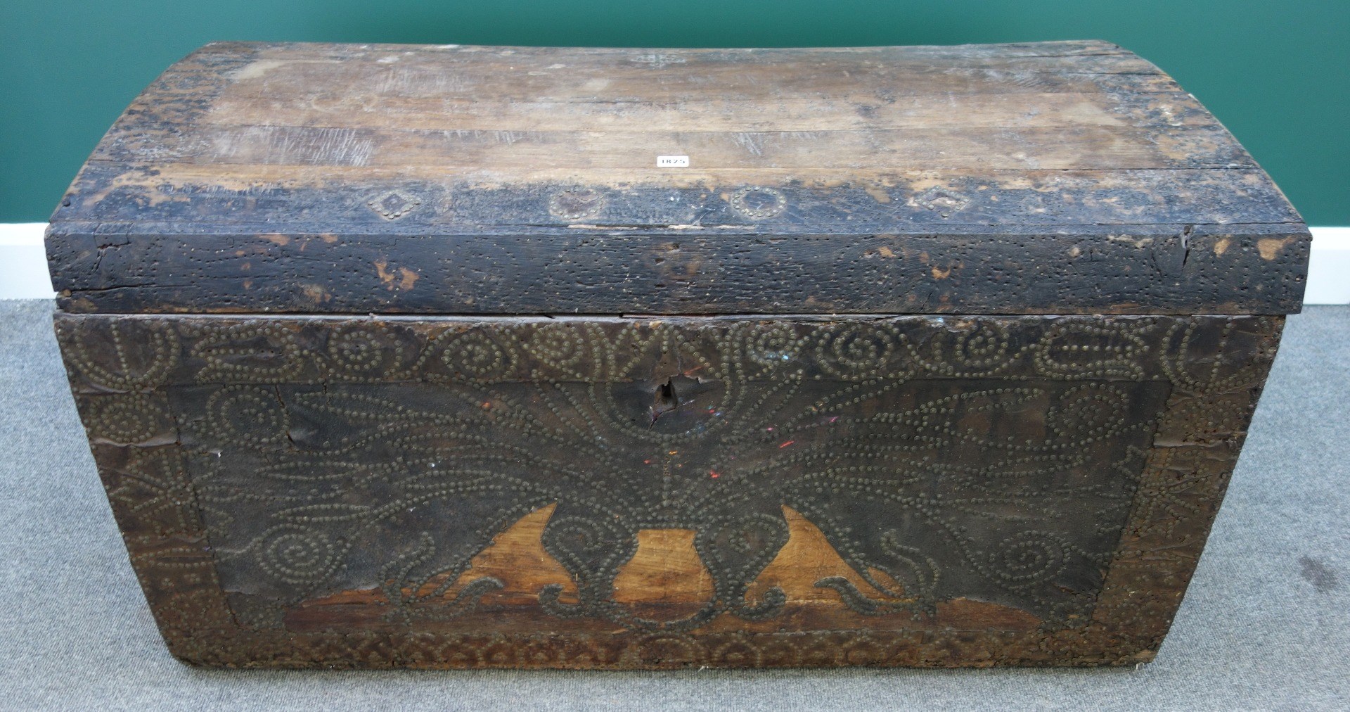 Appraisal: A brass studded leather veneered oak framed dome top trunk