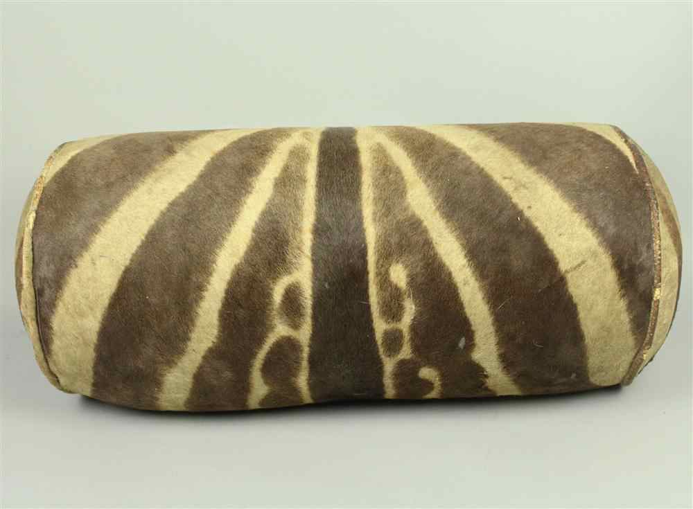 Appraisal: ZEBRA UPHOLSTERED SAUSAGE CUSHION AND A ZEBRA RUG JONAS BROS